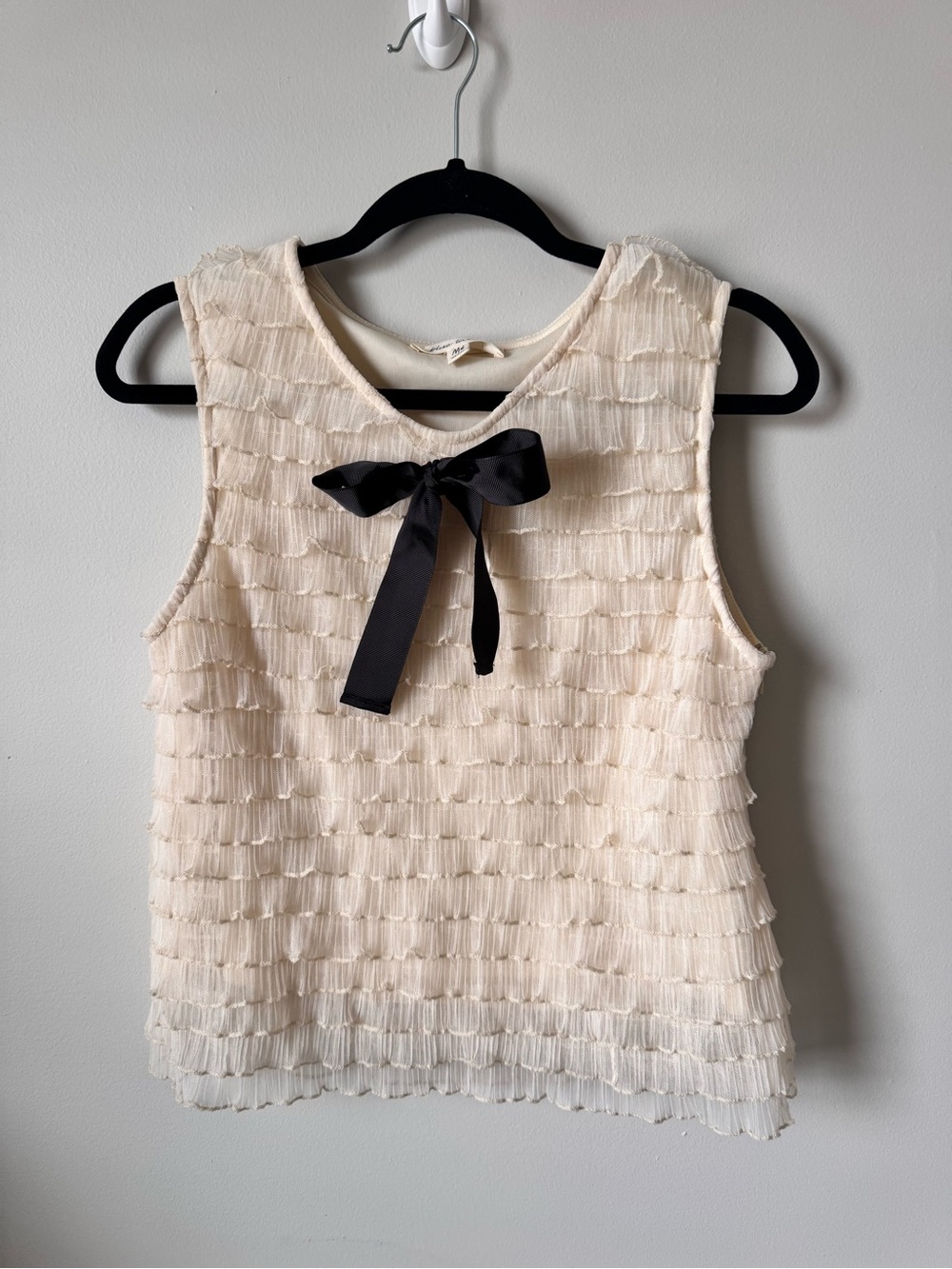 Ivory Sleeveless Ruffle Top with Black Bow